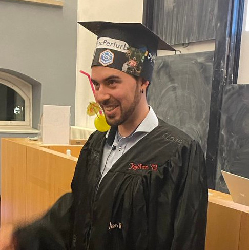 Stefan Peidli wearing doctoral cap and robe